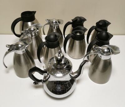 a group of coffee pots and tea kettles sitting on a table
