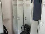 two lockers and a chair in a room