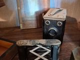 two old cameras sitting on a table next to each other