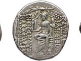 three silver coins with birds and flowers on them on a white background