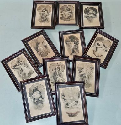 several framed pictures of dogs and cats are on a table