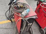 two welding machines that are sitting in the parking lot