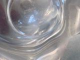 a clear glass vase with a red flower inside of it