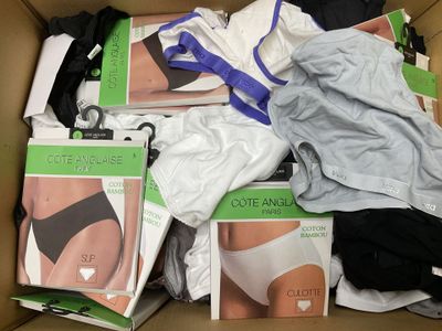 a cardboard box filled with underwear and underwear items
