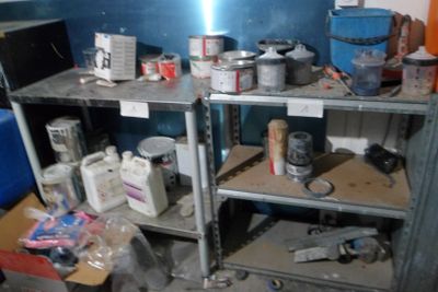 a metal shelf with various items on it in a room