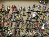 a box full of toy figurines of knights and knights