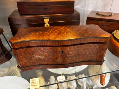 a glass display case with a wooden box on it