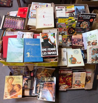 a lot of books that are sitting on the floor