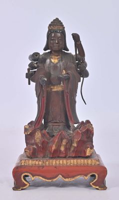 statue of a woman holding a bird on a stand