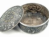 an image of a silver box sitting on top of a white surface