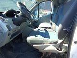 the interior of a car with the door open and the driver ' s seat down