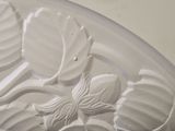 a close up of a glass bowl with a flower design on it
