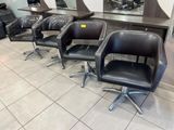 four chairs that are sitting in front of a mirror