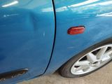 a close up of a blue car with its door open