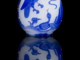 a blue and white vase with a picture of a man on it