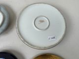 three plates and a bowl on a table with a label on them