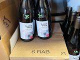 several bottles of wine sitting on top of a cardboard box