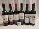 several bottles of wine are lined up on a table
