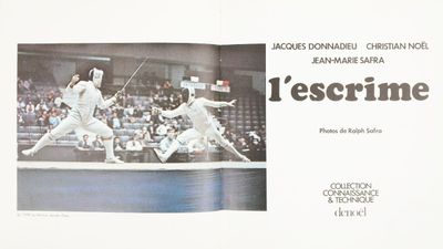 a book with a picture of two fencing players on it