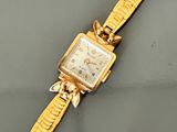 an image of a gold wrist watch with a chain around it