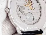 a close up of a watch in a person ' s hand