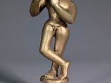 an image of a gold statue of a person on a pedestal
