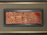 photo encadrée d'une plaque sur laquelle figurent les portraits d'un homme et d'une femme