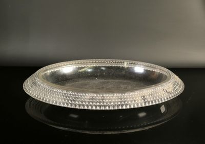 silver plate with beaded edge on a black surface