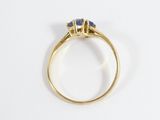 a close up of a gold ring with three sapphire stones