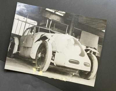 a black and white photo of a car in a garage