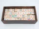 an old wooden box filled with wooden tiles with chinese writing