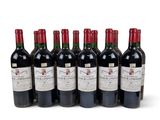 six bottles of red wine lined up in a row