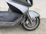 a scooter that is parked on the side of the road