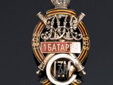 a badge with a crown on it on a black surface