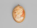 a gold - plated cameo of a woman wearing a pearl necklace