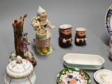 many different types of porcelain figurines displayed on the table