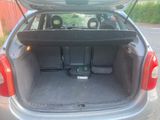 the back of a car with the trunk open and the seats folded down