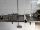 a metal shelf with a bunch of baskets on it
