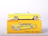yellow toy car sitting on top of a yellow box on a white surface