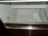 an image of an open refrigerator with a roll of toilet paper in it