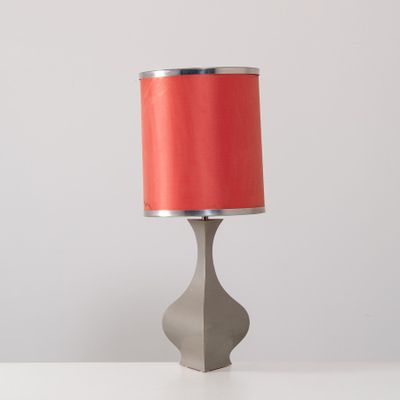 an image of a table lamp with a red shade on it