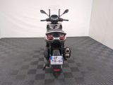 a motorcycle that is parked in a room with a checkered floor