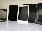 a lot of different types of cell phones on the table