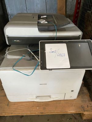 two printers sitting on top of each other on a pallet