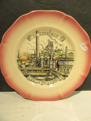 a plate with a picture of a factory on it