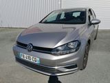 La Volkswagen Golf argentée est garée devant un immeuble.