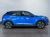a blue suv parked in a room with a white wall