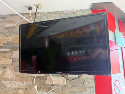 a flat screen tv mounted on a brick wall
