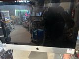 an apple computer monitor sitting on top of a desk in a store