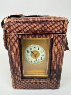 a small wicker box with a clock inside of it